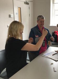 Pear Tree learning Club - Lynn experiments with a coat hanger and pegs!
